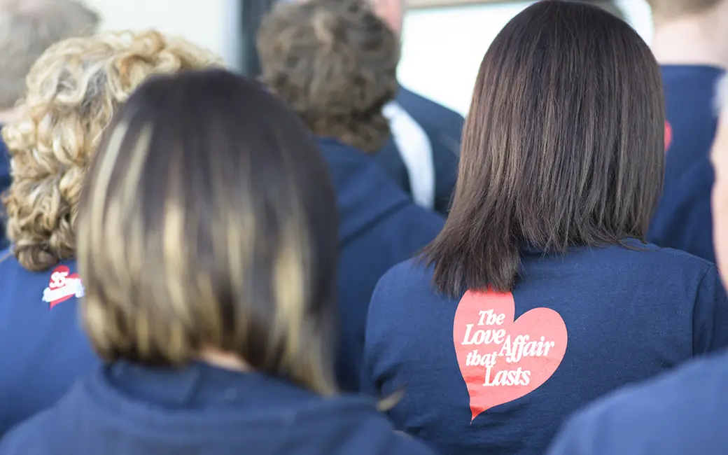 Lincolnberg team members in navy jackets with the company&rsquo;s red heart logo